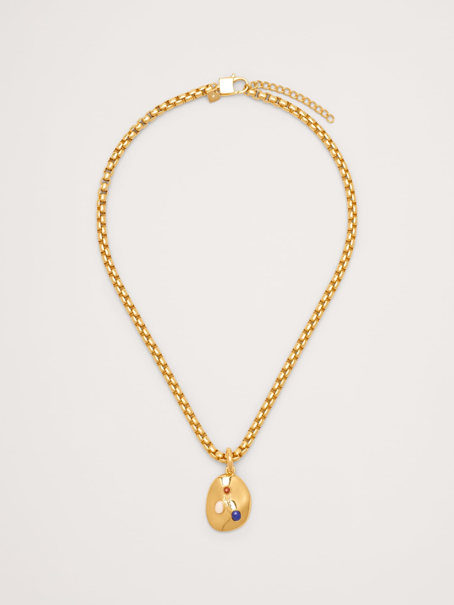 COLLIER À PENDENTIF OVALE SERTI DE PIERRES PRÉCIEUSES